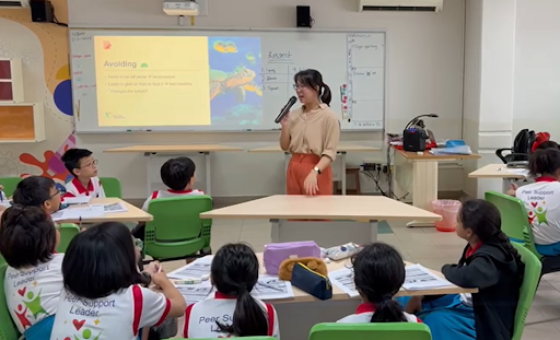 female trainer speaking in front of a class